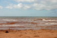 Waves tinted red from the red soil of PEI. PE.