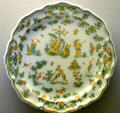 Faience plate painted with grotesque scenes by Manuf. Olerys et Laugier of Moustiers, France at Ariana Museum. Geneva, Switzerland.