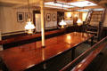 Elegant hardwood table & lights on board Rickmer Rickmers museum sailing ship. Hamburg, Germany.