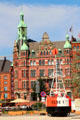Heritage buildings on Holländischer Brook canal beyond square with Elbe 1 buoy. Hamburg, Germany.