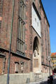 Southern side door with sundial & monument plaques of Frauenkirche. Munich, Germany.