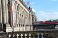 Passenger train crosses bridge between Bode & Pergamum Museum. Berlin, Germany.