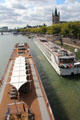 Busy Rhine River traffic seen from Hohenzollern Bridge with tour boat & barge in foreground. Köln, Germany