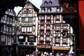 Row of half-timbered buildings in market square with fountain topped by statue of St Michael wielding his sword. Bernkastel-Kues, Germany.