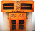 Wooden cabinet with glass doors & carved decorations by Paul Gauguin at Hamburg Decorative Arts Museum. Hamburg, Germany.