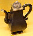 Meissen iron porcelain coffeepot with silver filigree lid at Meissen porcelain museum at Lustheim Palace. Munich, Germany.