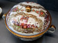Meissen porcelain chinoiserie lidded terrine accentuated with gold luster frames at Meissen porcelain museum at Lustheim Palace. Munich, Germany.