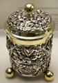 Ornately carved, lidded silver cup on "ball" feet with gold plated trim by goldsmith Adolf Gaap from Augsburg at Maximilian Museum. Augsburg, Germany.