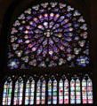 Rose window of Christ enthroned circled by apostles, saints & angels over vertical windows of saints & biblical figures in south transept of Notre Dame Cathedral. Paris, France.