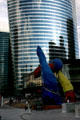 EDF building which is wider at top than bottom beyond Fantastic characters sculpture by Joan Miró at La Défense. Paris, France.