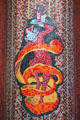 Mosaic sign of bar server wrapped in snake-like orange peel on rue de Seine in Latin Quarter. Paris, France.