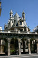 Open arcade spans gap between flanking buildings on rue Rivoli at Temple protestant de l'Oratoire du Louvre. Paris, France