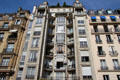 Apartment building with undulating facade decorated with various tiles. Paris, France.