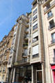Apartment building projecting forward from usual flat facade plane of Paris for more light. Paris, France.