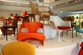 Armchairs orange by Joe Colombo of Italy & white Tulip by Eero Saarinen from Finland at Museum of Decorative Arts. Paris, France.