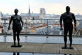 Sculpture group on upper deck at Georges Pompidou Center with Notre Dame cathedral beyond. Paris, France.