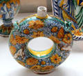 Ceramic torus gourd painted with putti & sunflowers from Nevers, France at Sèvres National Ceramic Museum. Paris, France.