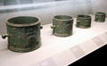 Five standard bronze measures for grains from Paris with double L symbol of Louis XIV at Arts et Metiers Museum. Paris, France.