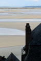 Roofs of Mont-St-Michel in profile against massive tidal flats. Mont-St-Michel, France.