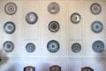 Rouen-made earthenware plates in several blue patterns at Rouen Ceramic Museum. Rouen, France.