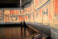 Visitors studying Apocalypse Tapestry at Angers Chateau. Angers, France.