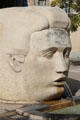 Head of god Nemausus on Nemausa fountain sculpture by Martial Raysse at Place d' Assas. Nimes, France