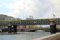 Commuter train on Loopline rail bridge over River Liffey. Dublin, Ireland.