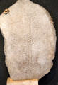 Grave slab reading "prayer for servant of Michael" in Irish at Clonmacnoise museum. Ireland.