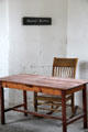 Wooden table & chair in Matron's kitchen at Irish Workhouse Centre. Portumna, Ireland.