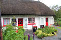 Thatched roof & red trimmed cottage. Adare, Ireland.