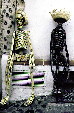 Two artistic skeletons sit on a wall in Taxco. Mexico.