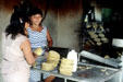 Women make tortillas at Izamal market. Mexico.