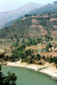 Suspension bridge across mountain river seen from road to Katmandu. Nepal.