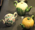 Ceramic teapots in village, cauliflower & pineapple shapes from Staffordshire, England at National Museum of Scotland. Edinburgh, Scotland.