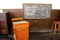 Blackboard & teacher's desk in Victorian classroom at Scotland Street School Museum. Glasgow, Scotland.