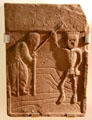 Stone tombstone shows death as skeleton talking to old woman at Arbroath Abbey. Arbroath, Scotland