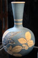 Salopian bottle vase incised with bird & bramble on light blue�background by Benthall Pottery at Jackfield Tile Museum. Ironbridge, England.