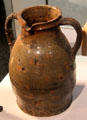 Red earthenware two handled jar with greenish glaze from Cambridge at Potteries Museum & Art Gallery. Hanley, Stoke-on-Trent, England.