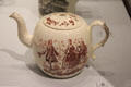 Queen's Ware transfer-printed over glaze teapot with dancing figures beside violin player by Wedgwood at World of Wedgwood. Barlaston, Stoke, England.