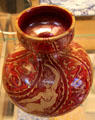 Earthenware red lustre vase with mermaids exhibited at Arts & Crafts Exhibit by Walter Crane & made by Maw & Co, Broseley, Shropshire at British Museum. London, United Kingdom.