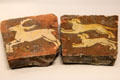 Dog chasing stag earthenware floor tiles from France at British Museum. London, United Kingdom.