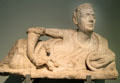 Etruscan carved alabaster cinerary urn lid with reclining man holding horse rhyton prob. from Volterra at British Museum. London, United Kingdom.