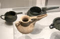 Spouted bronze jars riveted together plus pottery imitations with clay pellets mimicking rivets excavated from western Iran at British Museum. London, United Kingdom.
