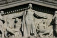 Detail of central female figure protecting power & knowledge on pediment of Jesse Unruh State Office Building. Sacramento, CA.