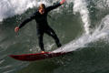 Surfing beside pier in Ocean Beach. San Diego, CA.