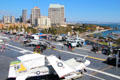 San Diego skyline over Midway aircraft carrier & aircraft. San Diego, CA.