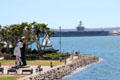 Unconditional Surrender giant sculpture of victory kiss & aircraft carrier seen from Midway. San Diego, CA.