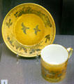 Gilded porcelain cup & saucer in caramel from Sèvres, France at Legion of Honor Museum. San Francisco, CA.