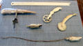 Ivory scrimshaw objects carved by whalers includes corkscrew, ruler, jagging wheels & whistle at National Maritime Museum. San Francisco, CA.