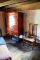 Tall chest of drawers with half-arm chair at Stanley-Whitman House. Farmington, CT.